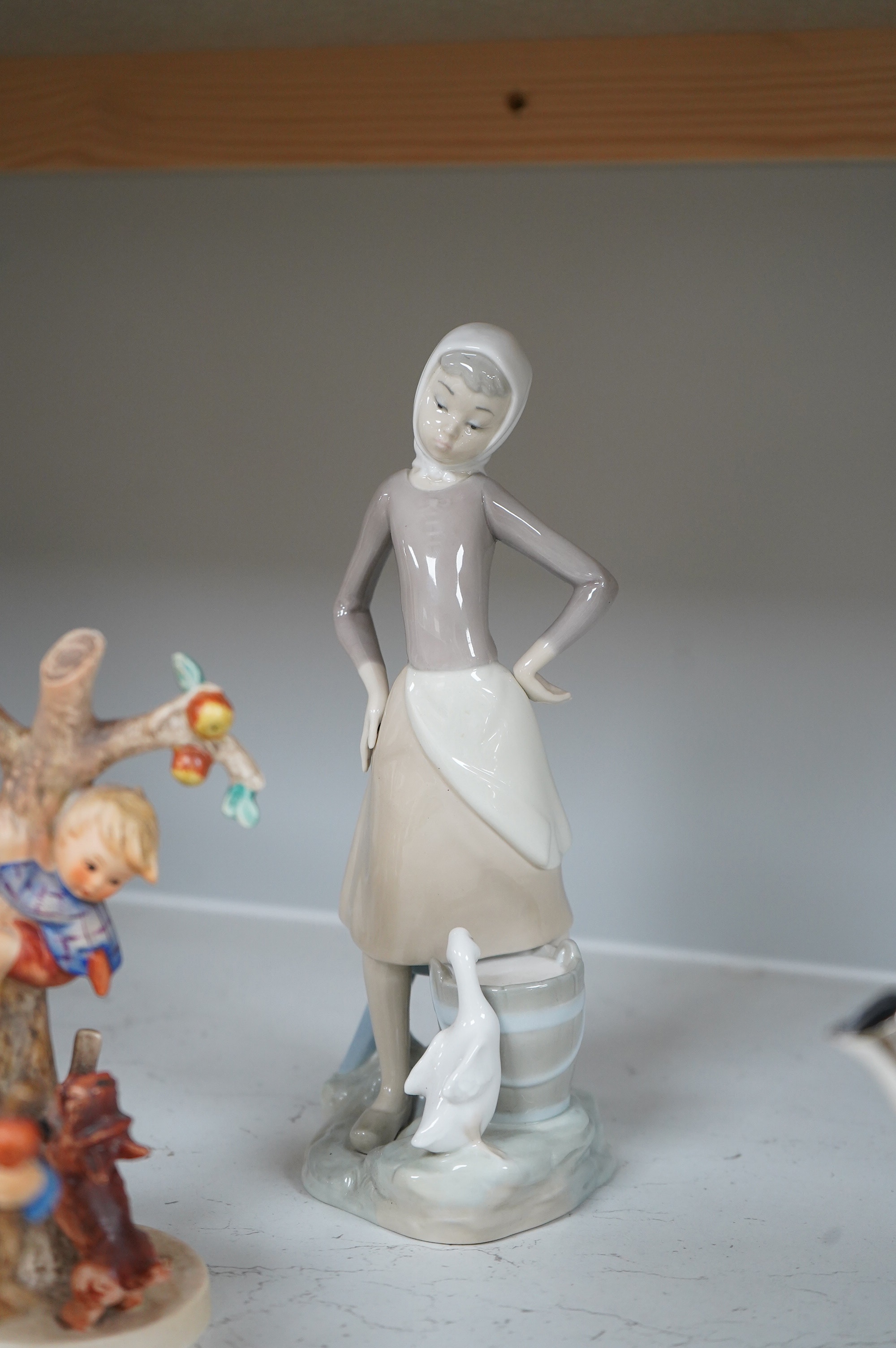 Six various Goebel figures and a Lladro figure, 24cm high
